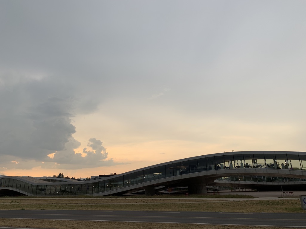 Low modern building under a large sky at dusk